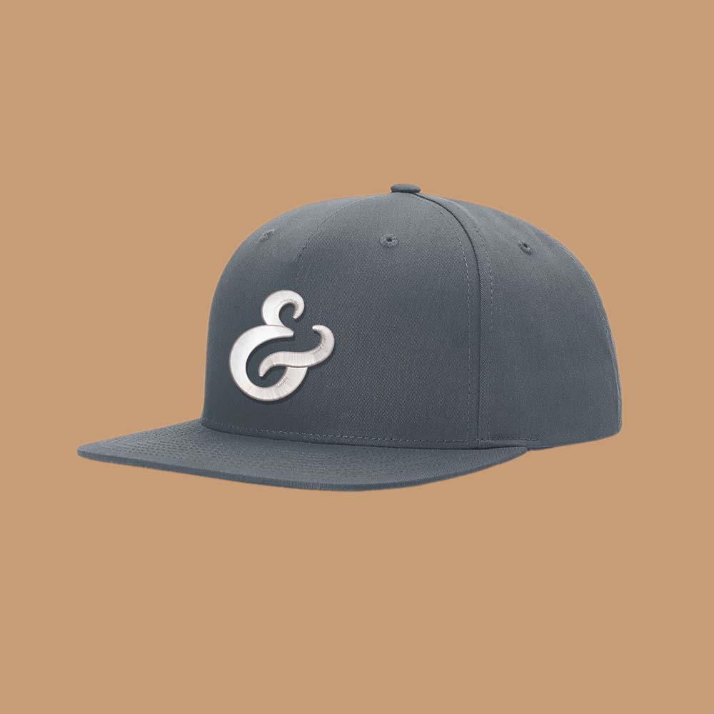 Gray snapback hat with a white ampersand embroidered on the front