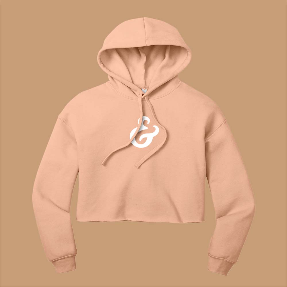 Peach cropped hoodie with a white ampersand on the front